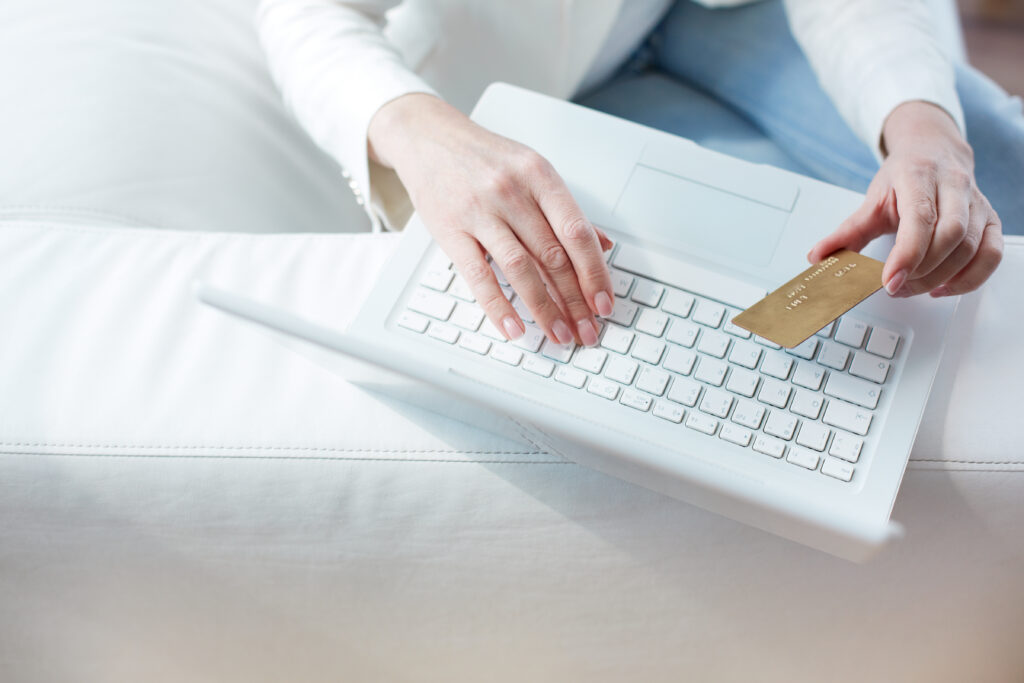 close up female hands making online payment scaled